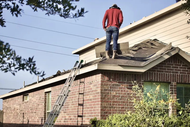 Professional roofer working on a residential roof in Westwind